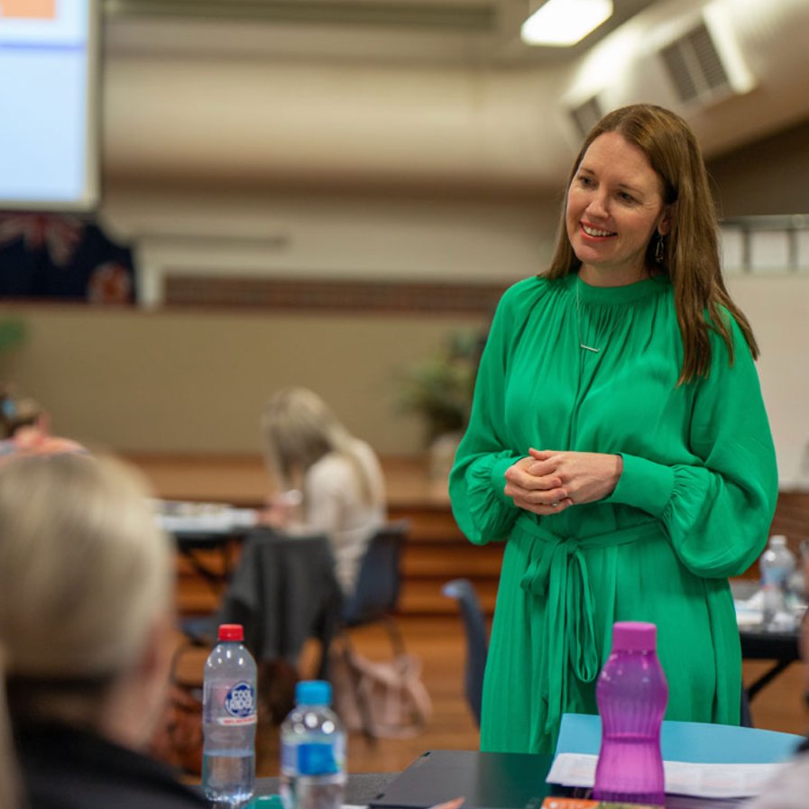 Julie Scali talking with a team of teachers during professional learning