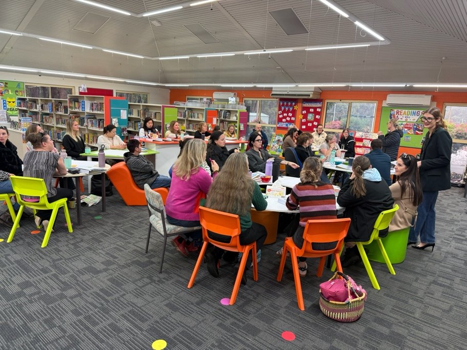Teachers working together at a literacy professional learning day in a school library